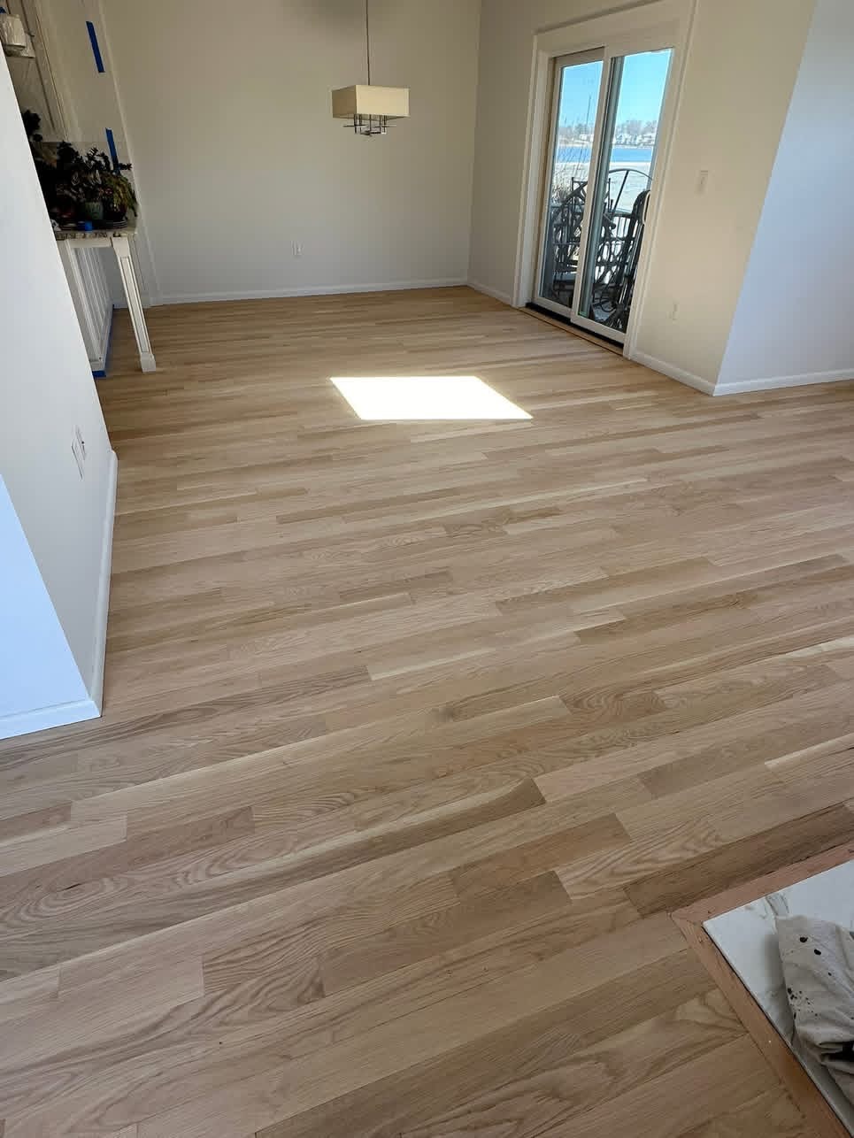Newbury engineered hardwood floors — warm honey-toned planks throughout a dining room